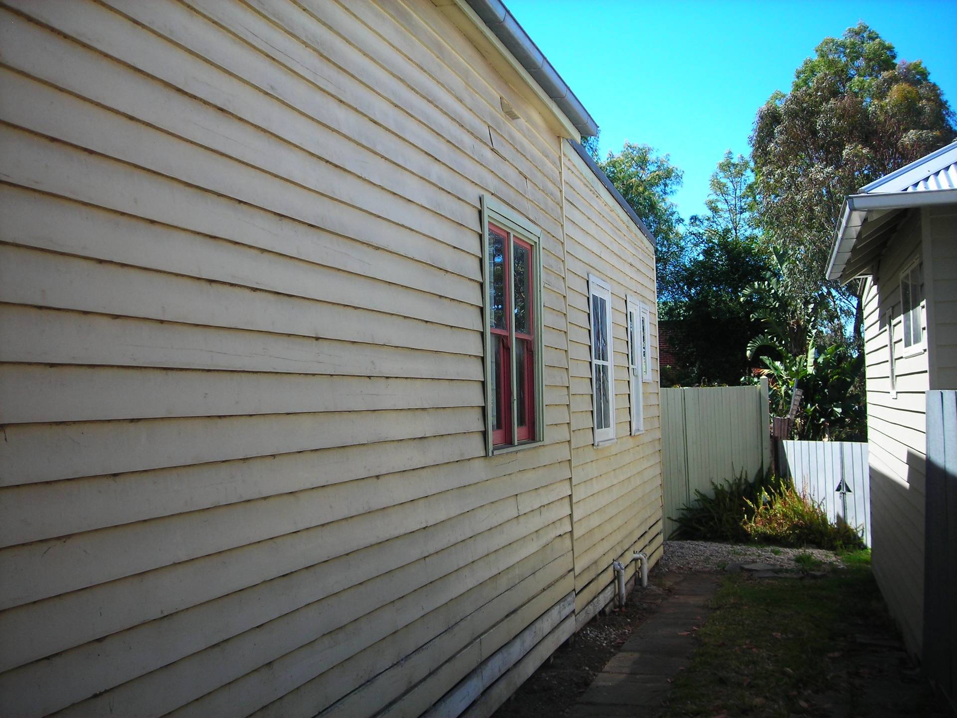 Side wall, both the original house and weatherboards on the home extension need replacing.
