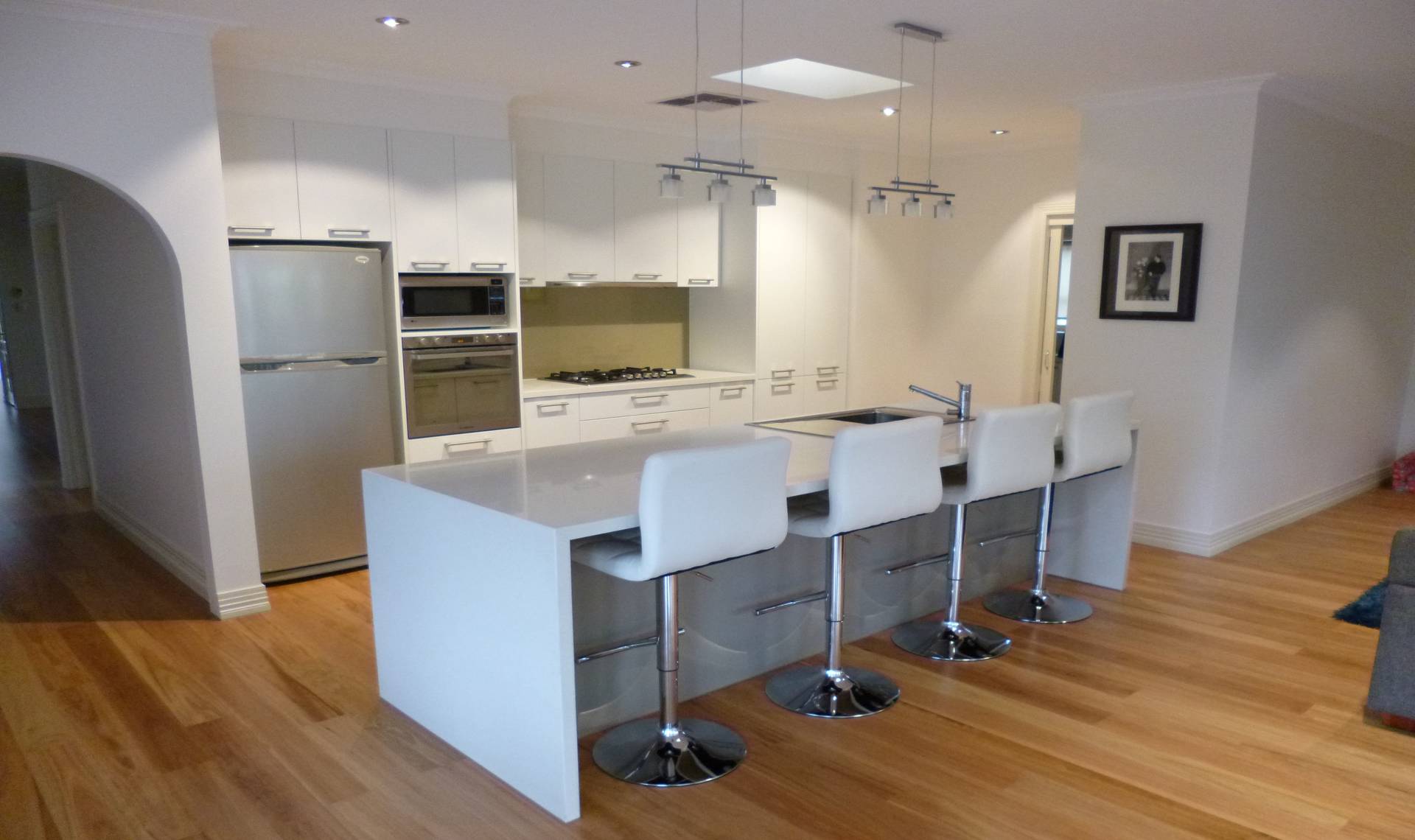 Brand new vinyl wrap and caeser stone top kitchen with glass splashback.