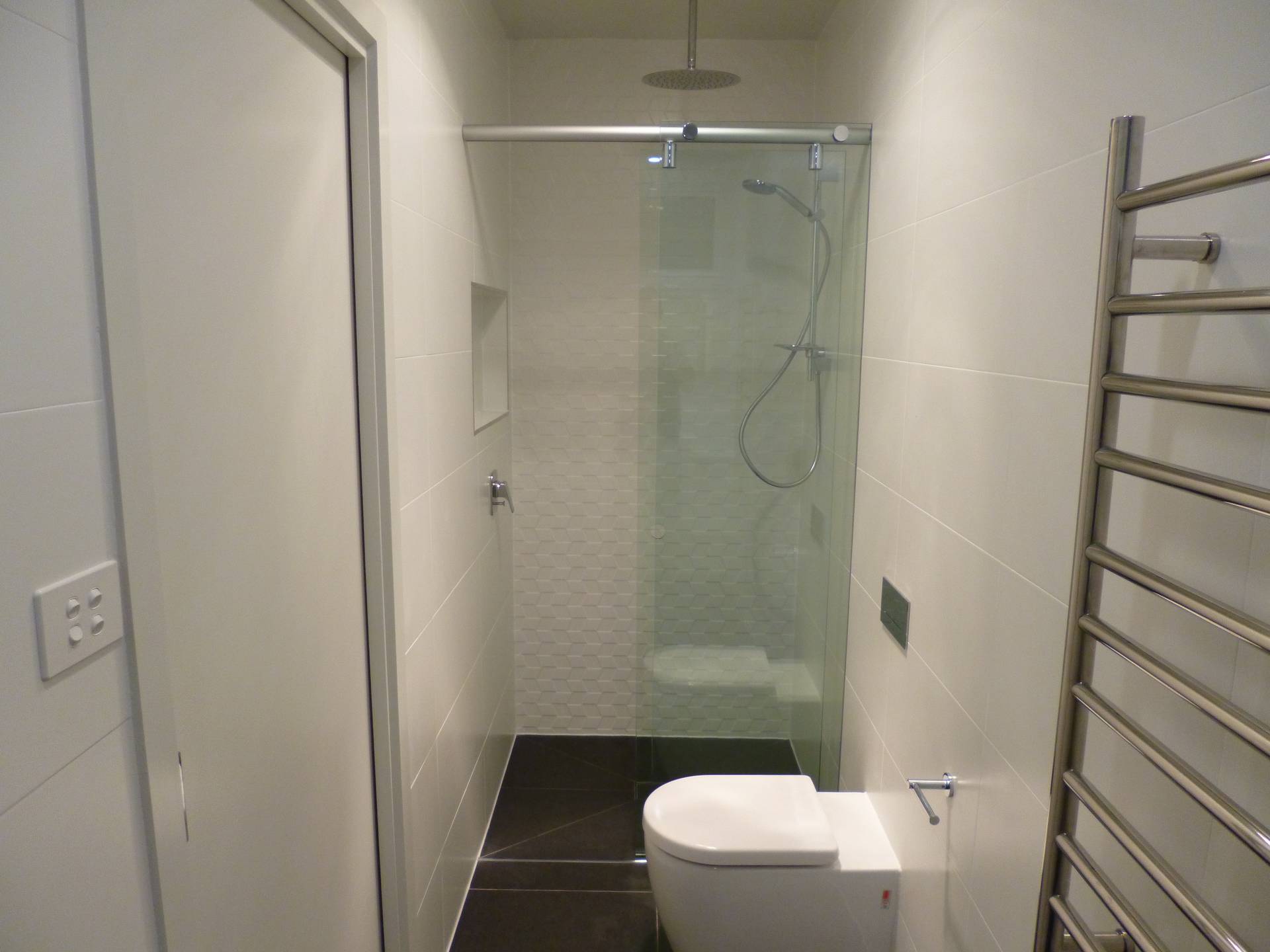 Completion of the home extension with plumbing fittings and sliding door frameless glass shower screen installed.